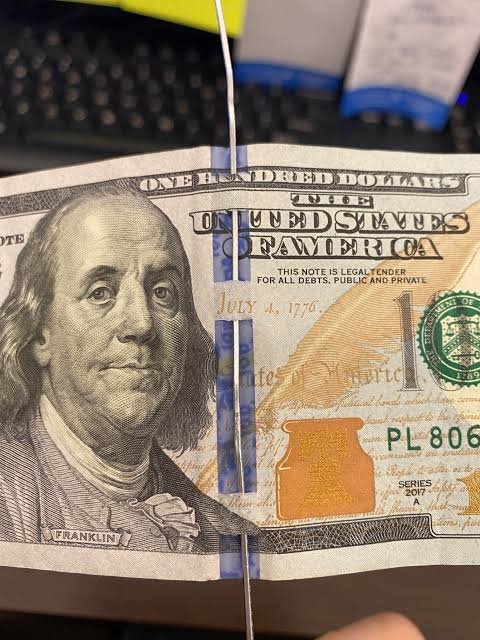 Security ribbon on 100 dollar bill.